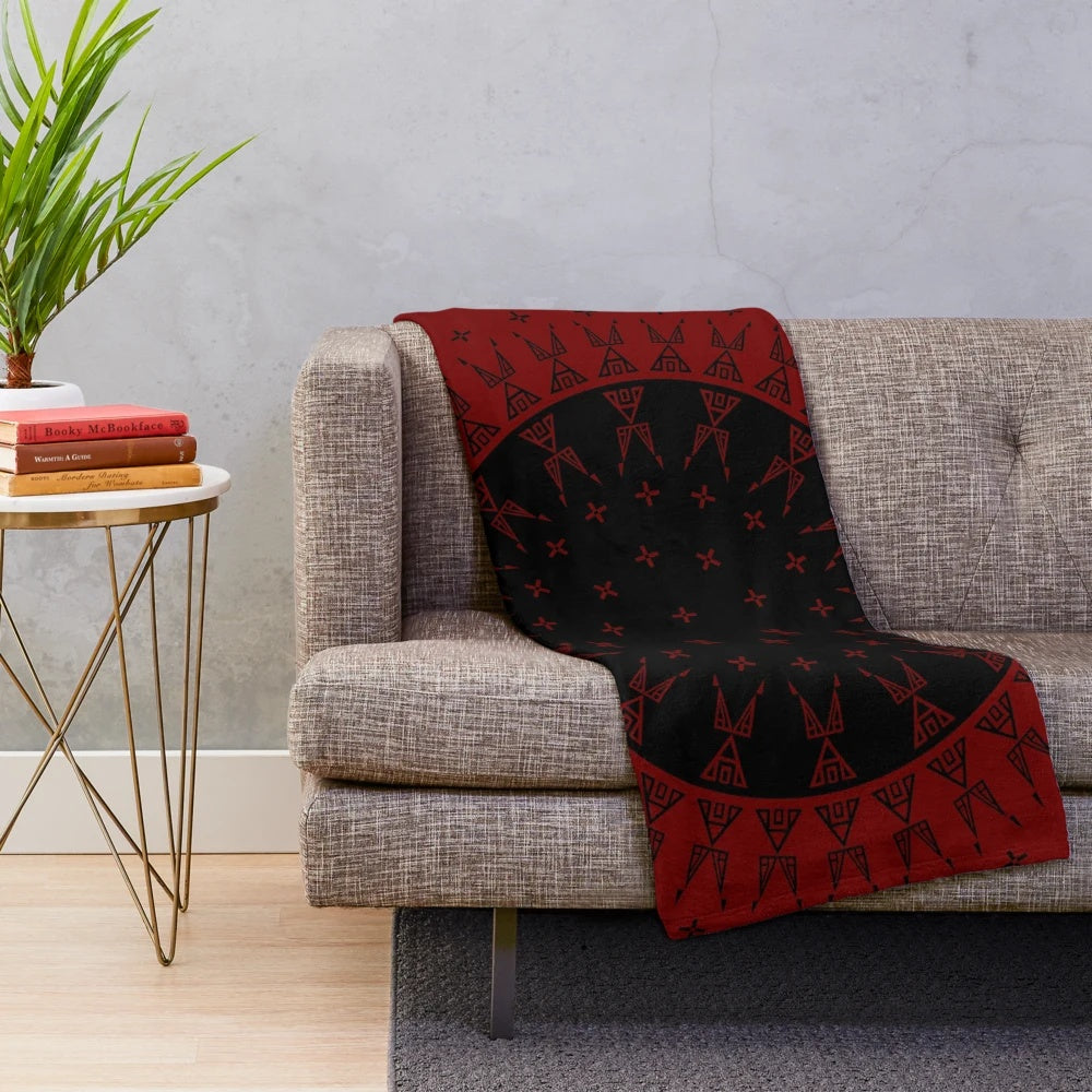 Maroon and black plush blanket with native-inspired wildlife and star designs