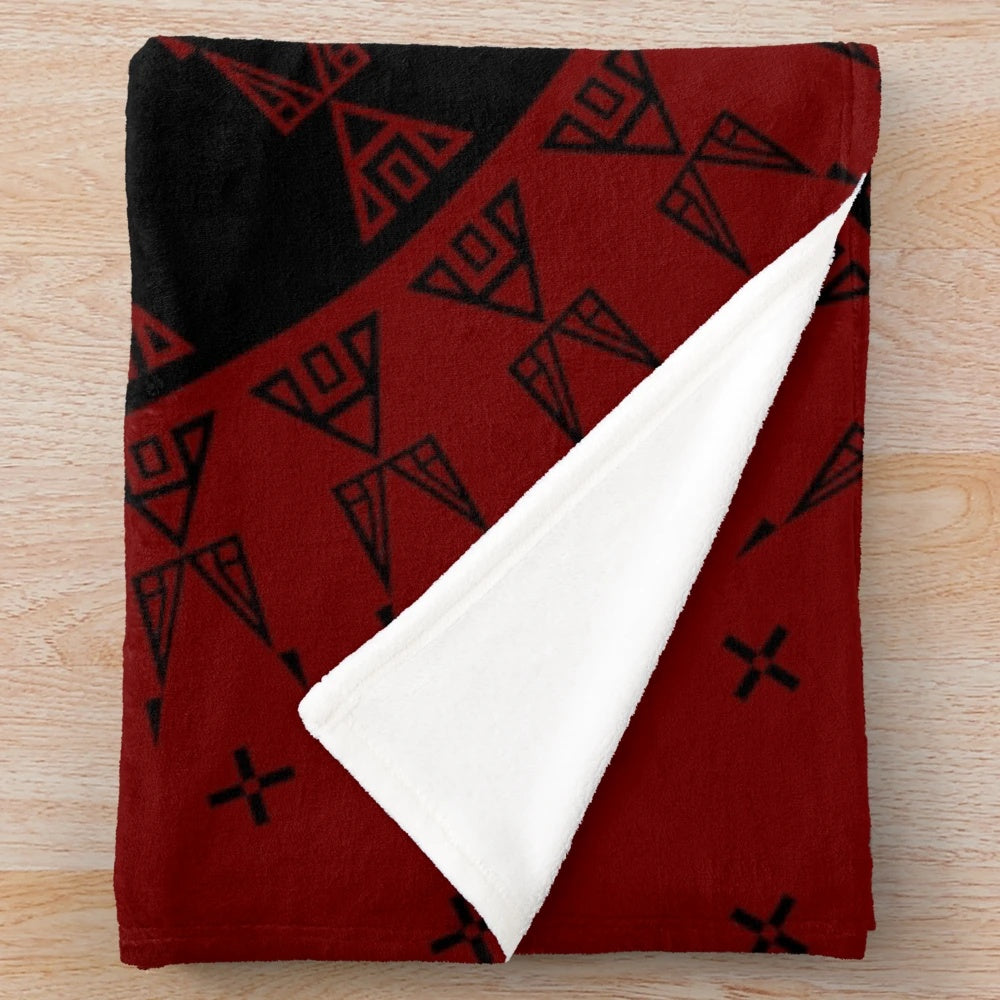Maroon and black plush blanket with native-inspired wildlife and star designs