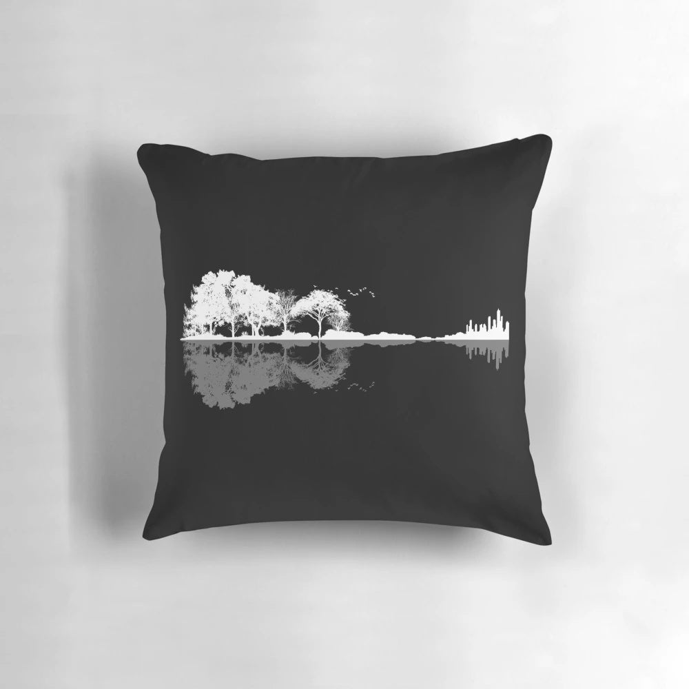 A beautiful, nature-inspired guitar-shaped pillow featuring a silhouetted landscape with trees, water, and birds.