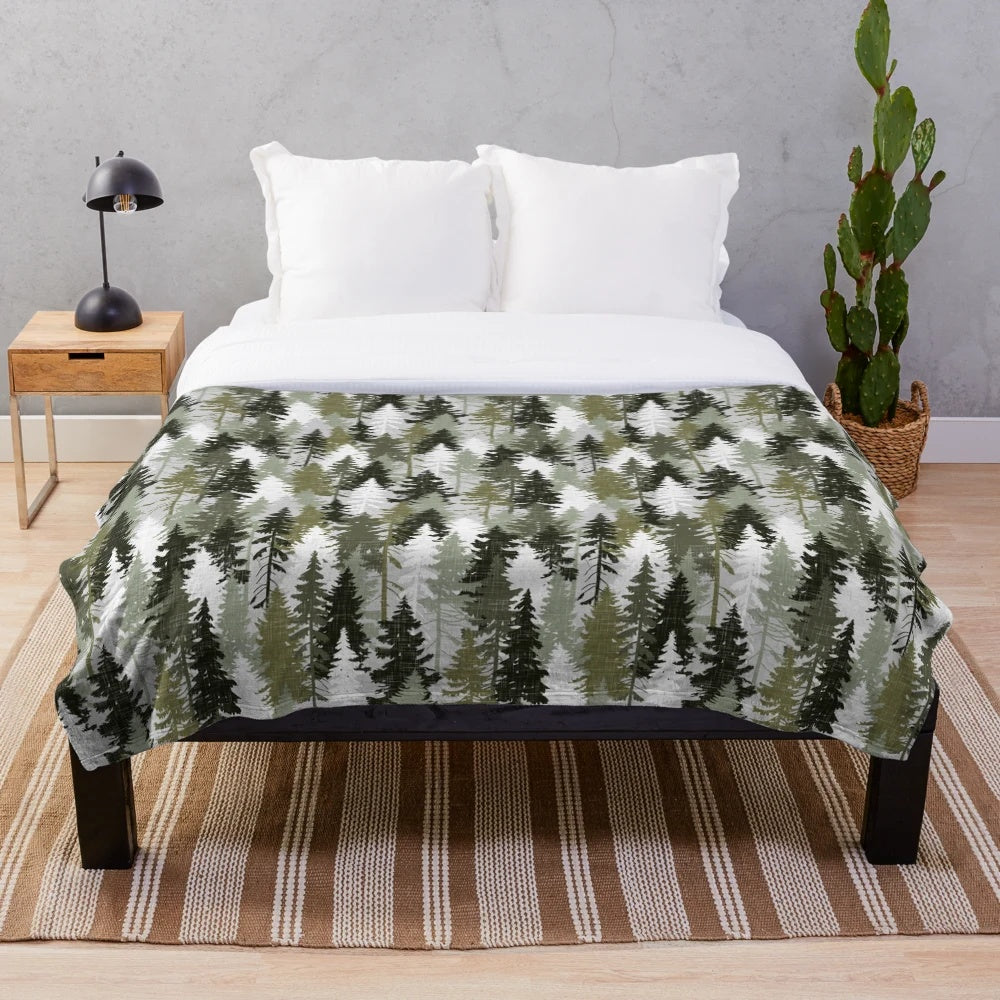 Plush blanket featuring a hand-drawn forest of pine trees in olive and grey tones