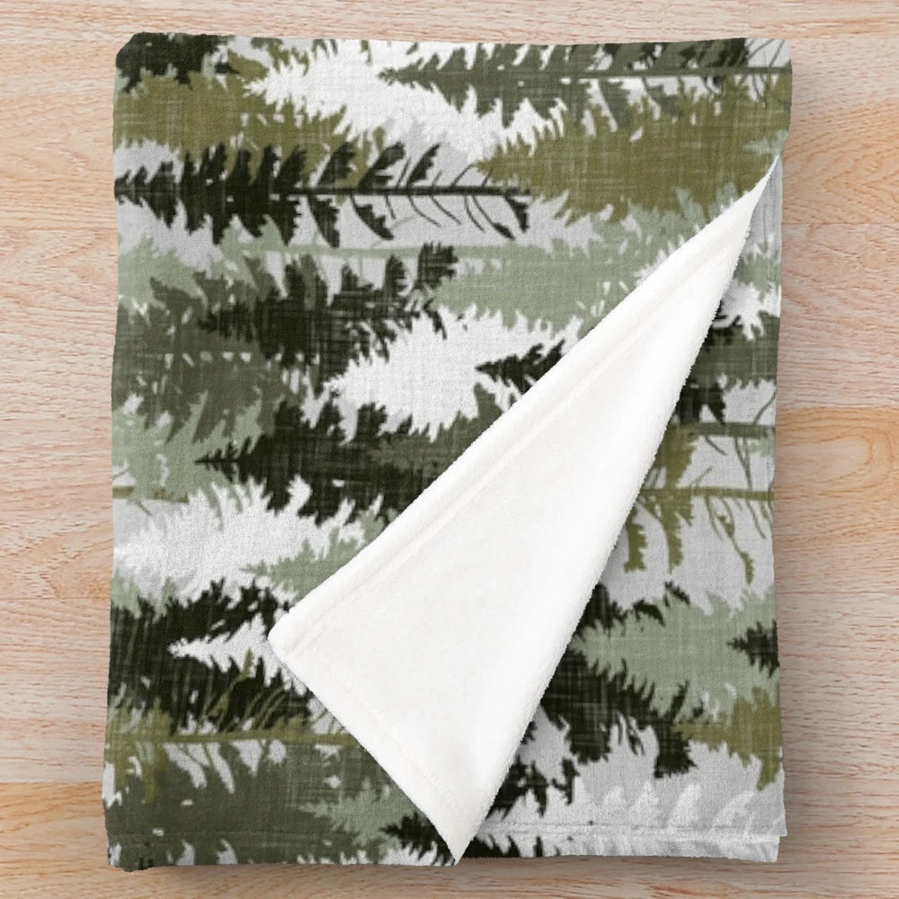Plush blanket featuring a hand-drawn forest of pine trees in olive and grey tones