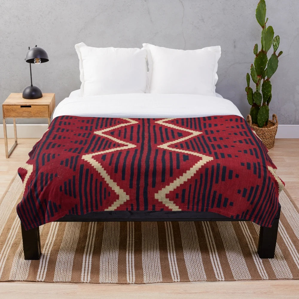 Navajo-inspired plush blanket with geometric patterns in vibrant colors