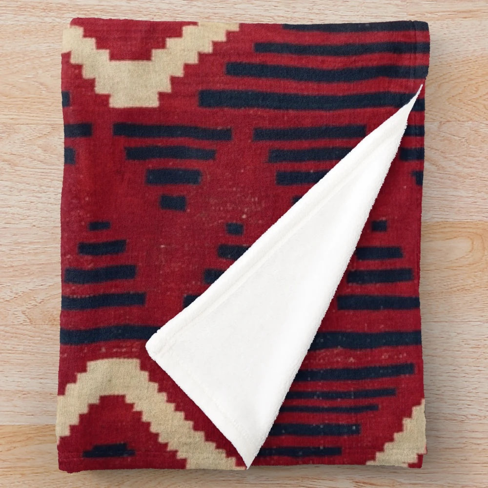 Navajo-inspired plush blanket with geometric patterns in vibrant colors