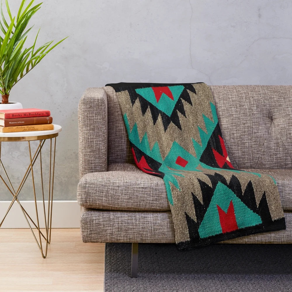 Navajo patterned plush blanket in turquoise, red, grey, and black