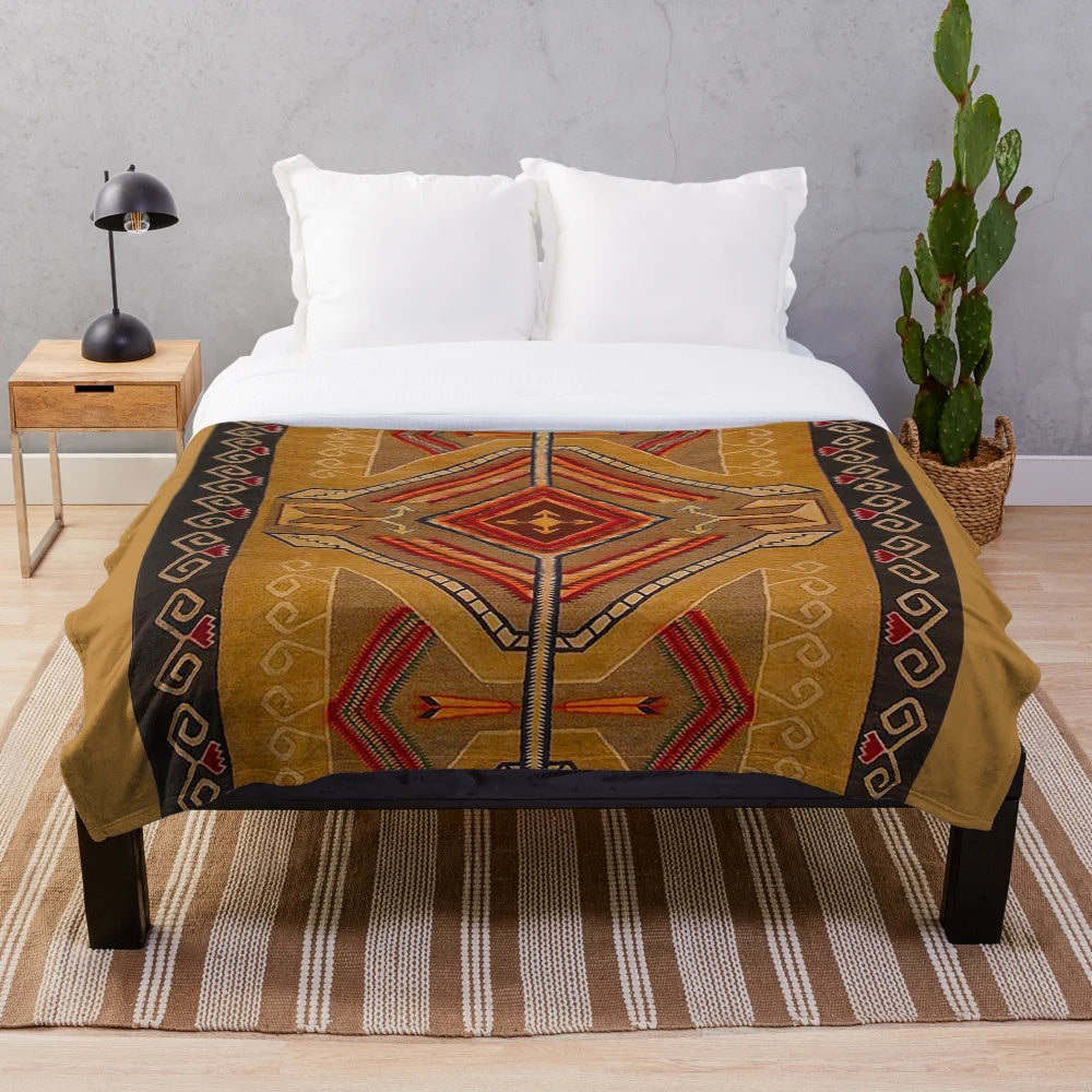 Navajo-inspired plush blanket in red, yellow, and brown southwestern pattern