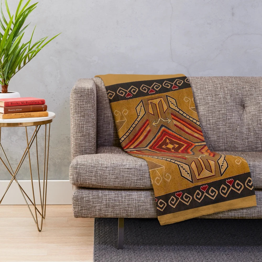 Navajo-inspired plush blanket in red, yellow, and brown southwestern pattern