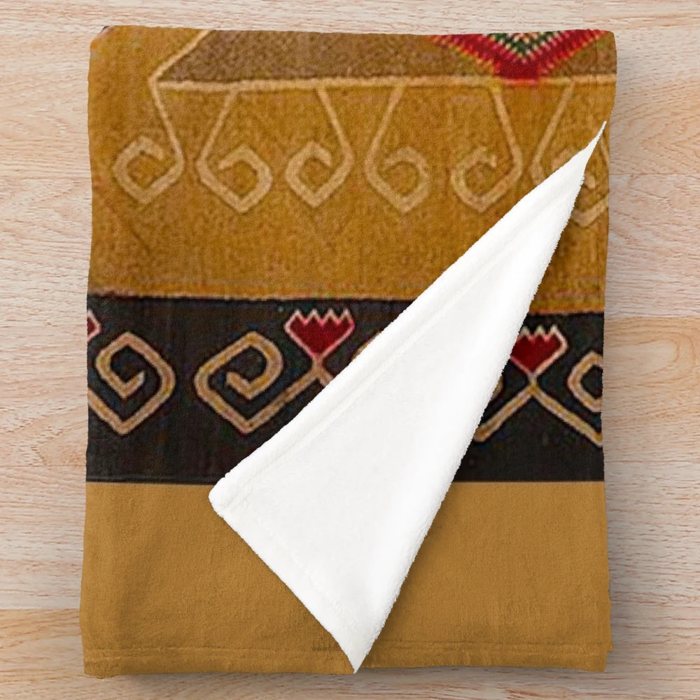 Navajo-inspired plush blanket in red, yellow, and brown southwestern pattern