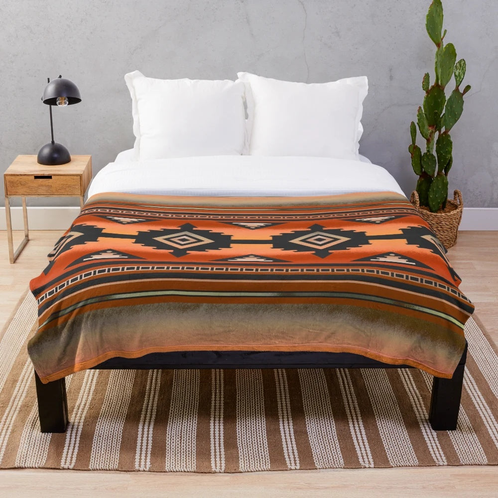 Rust and teal plush blanket with Navajo-inspired geometric pattern