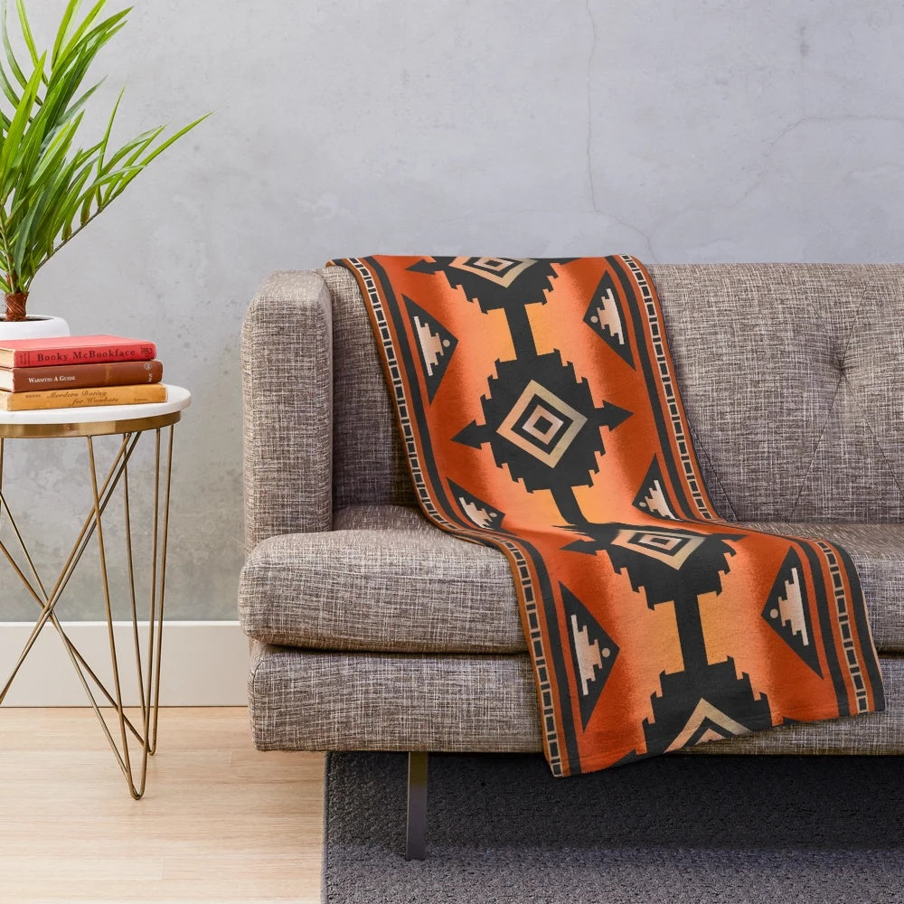 Rust and teal plush blanket with Navajo-inspired geometric pattern