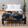 Navy and orange geometric pattern plush blanket