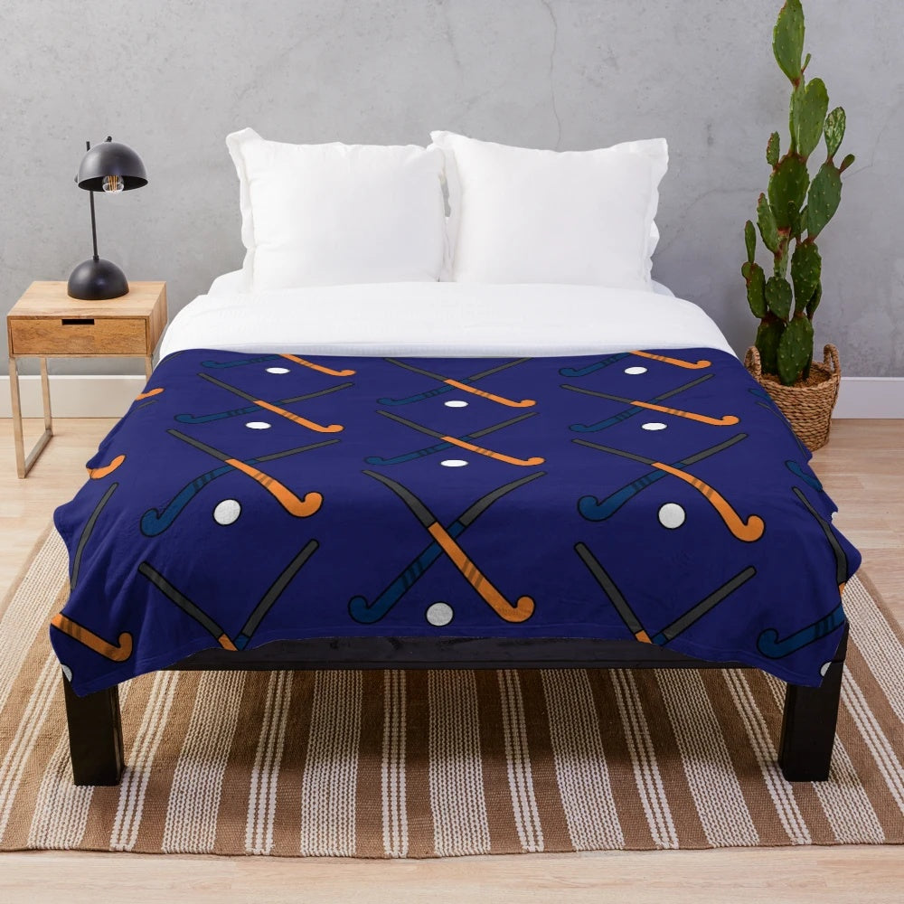 Navy and orange plush blanket with field hockey design