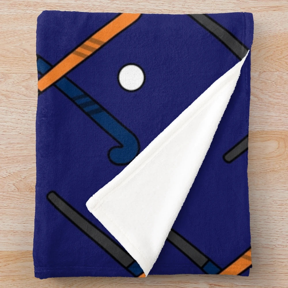 Navy and orange plush blanket with field hockey design