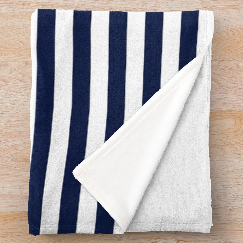 Navy blue and white striped plush blanket with anchor pattern