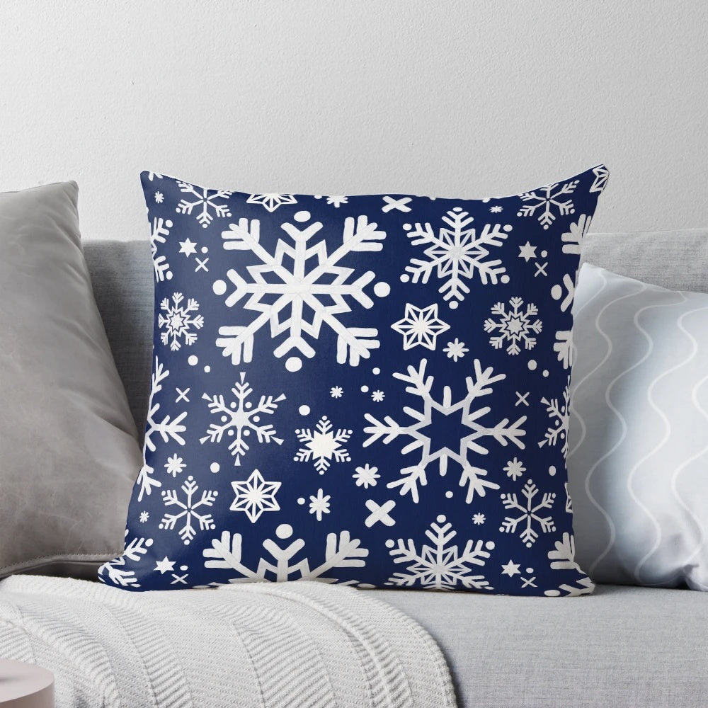 A navy blue pillow with a snowflake pattern, perfect for winter and holiday home decor.