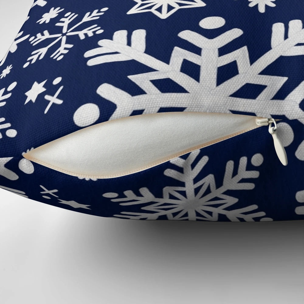 A navy blue pillow with a snowflake pattern, perfect for winter and holiday home decor.