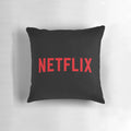 A soft, plush pillow featuring the Netflix logo in black and red colors.