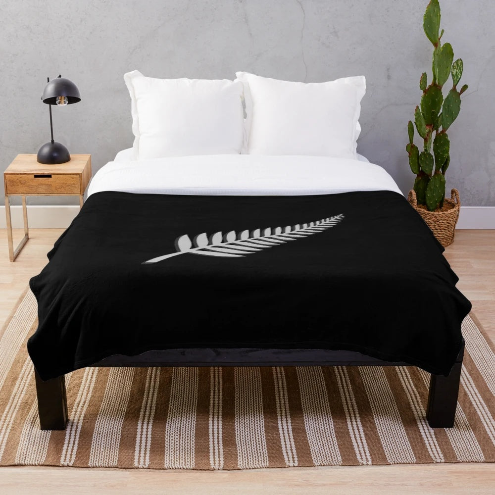 New Zealand inspired plush blanket with kiwi bird and silver fern emblem design
