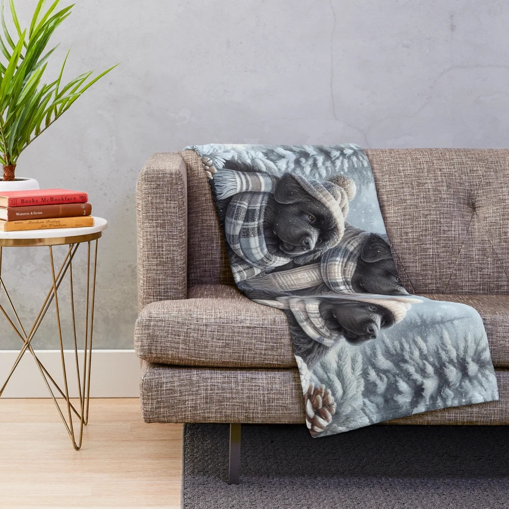 Newfoundland dog wearing winter hat and scarf on a plush blanket
