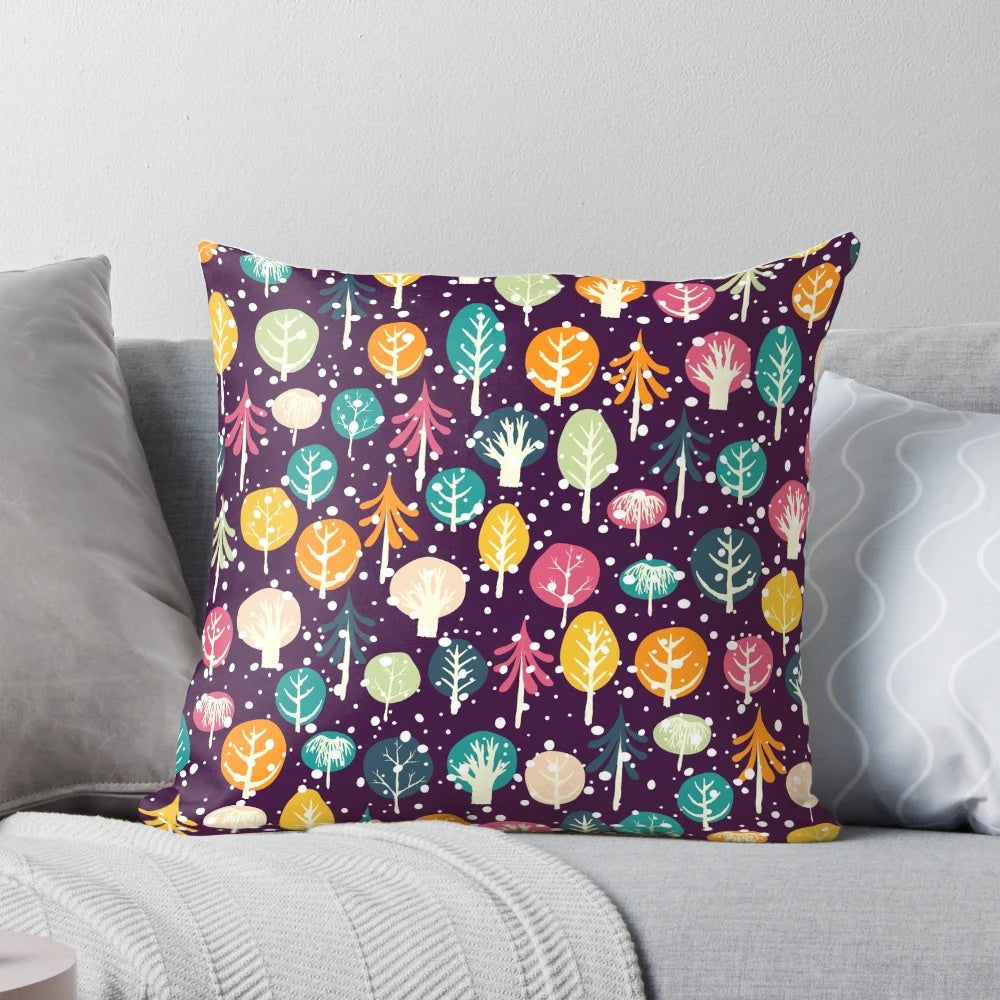 Soft, plush pillow featuring a winter forest scene with fir trees, snow, and snowflakes
