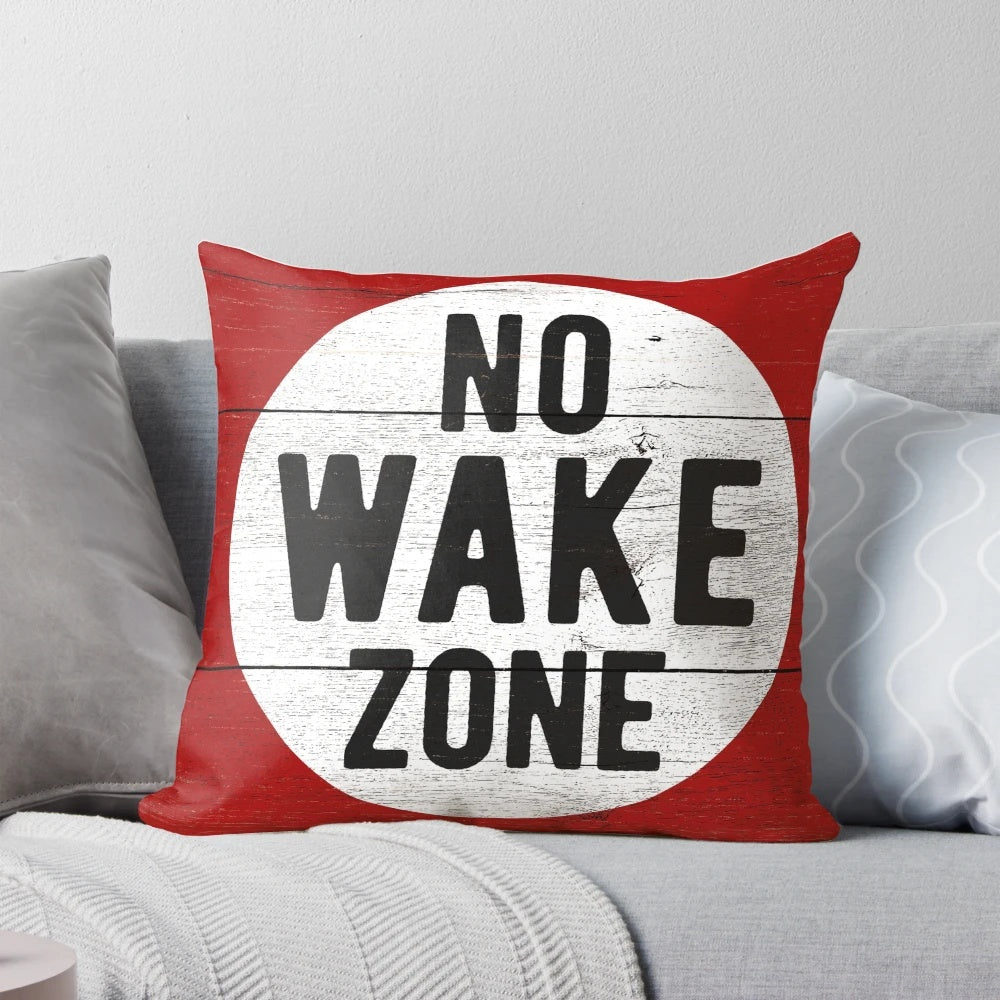 Soft, plush pillow with a no wake zone sign design, perfect for lake house decor or gift for boating enthusiasts.