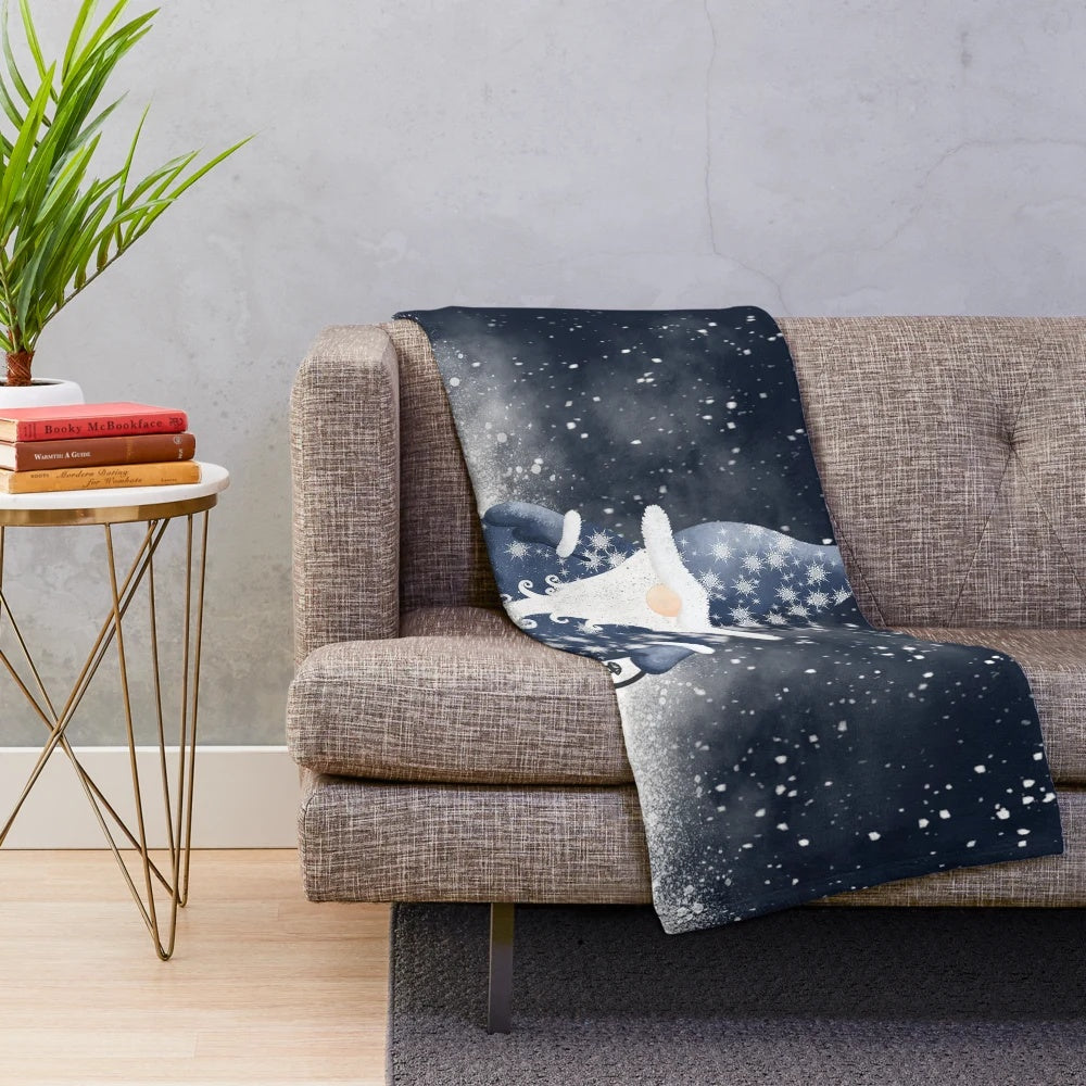 A soft, plush blanket featuring a cute Nordic gnome design with snowflakes