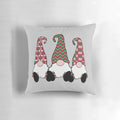 A festive throw pillow featuring adorable Nordic gnomes or tomte elves in traditional Scandinavian red hats.