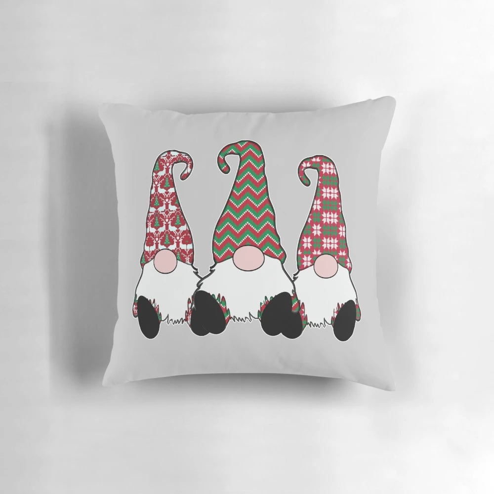 A festive throw pillow featuring adorable Nordic gnomes or tomte elves in traditional Scandinavian red hats.