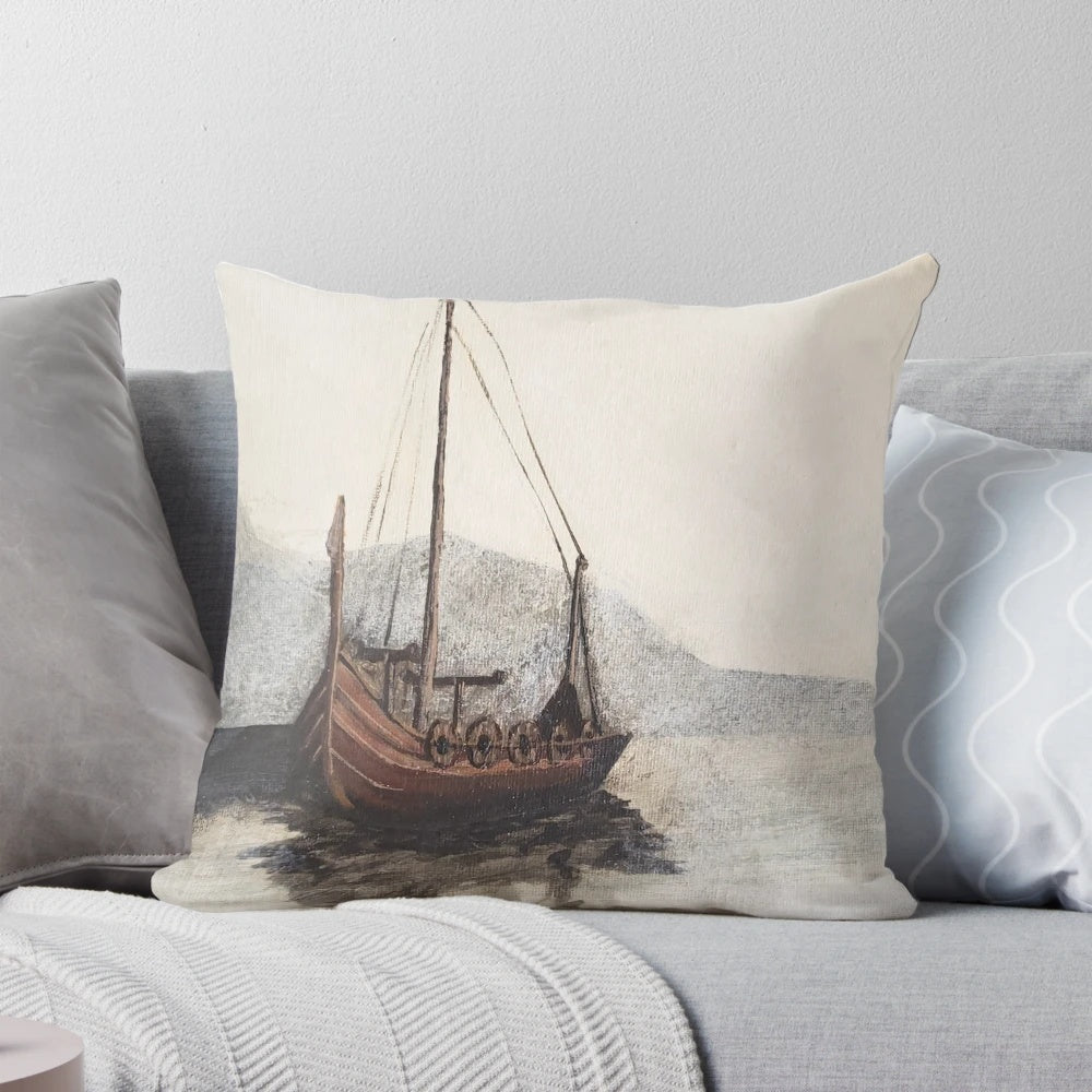 A cozy decorative pillow featuring a moody, foggy seascape painting of a lone viking ship on the water, surrounded by mountains.