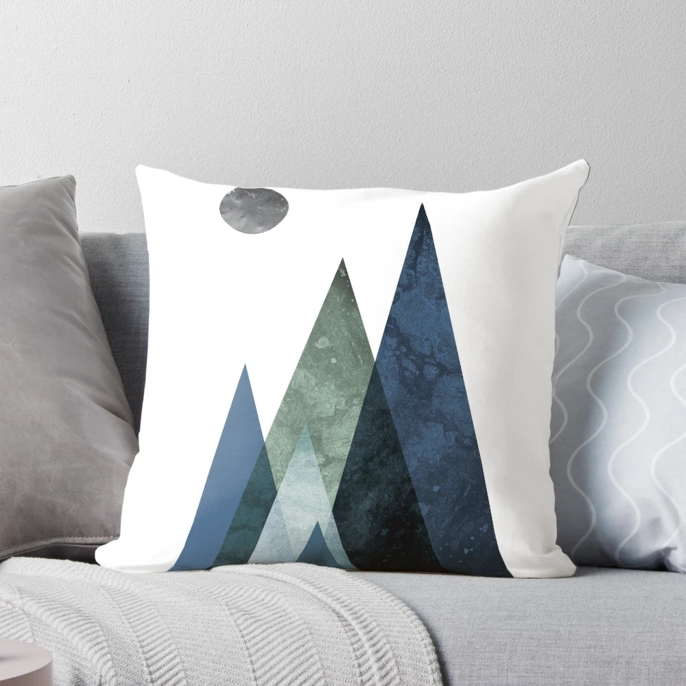 A navy blue and hunter green minimalist mountain art pillow with a simple, modern design.