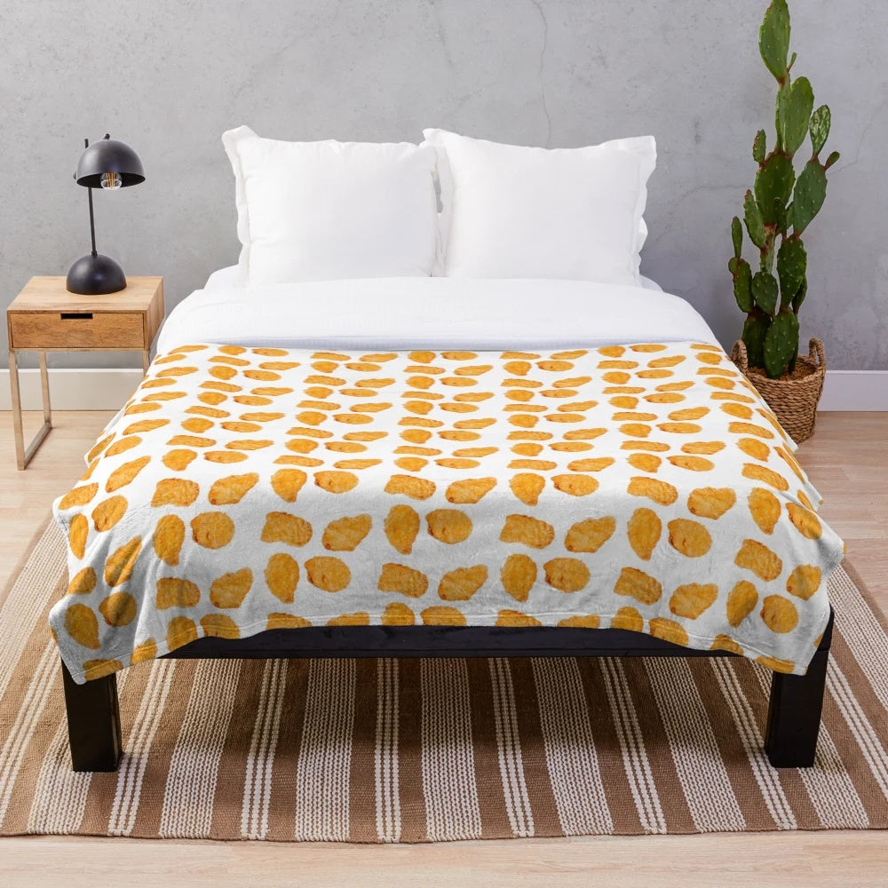 Soft and cuddly plush blanket with a chicken nugget design