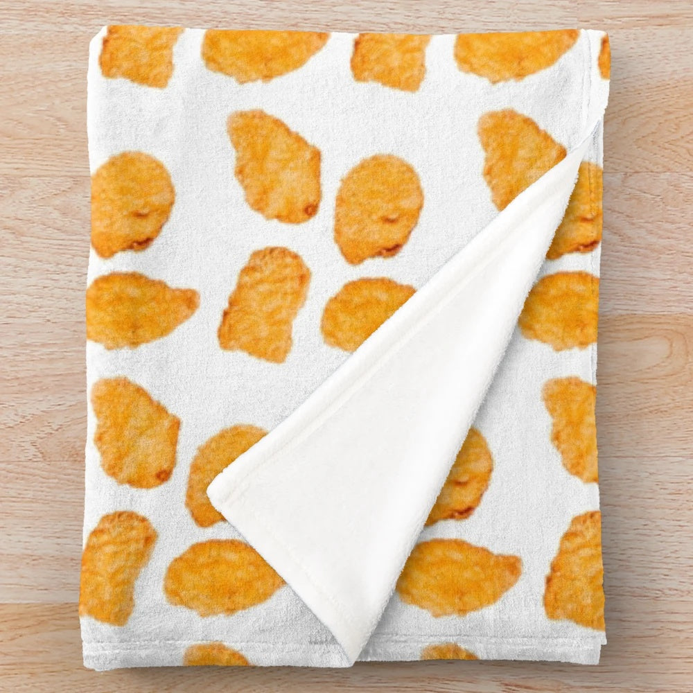Soft and cuddly plush blanket with a chicken nugget design