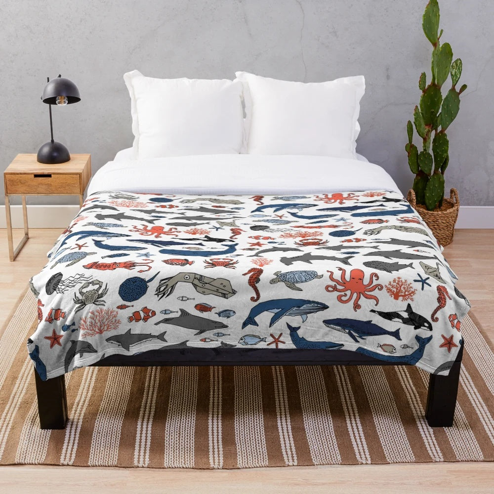 Soft and plush ocean animals blanket featuring a vibrant design by artist Andrea Lauren