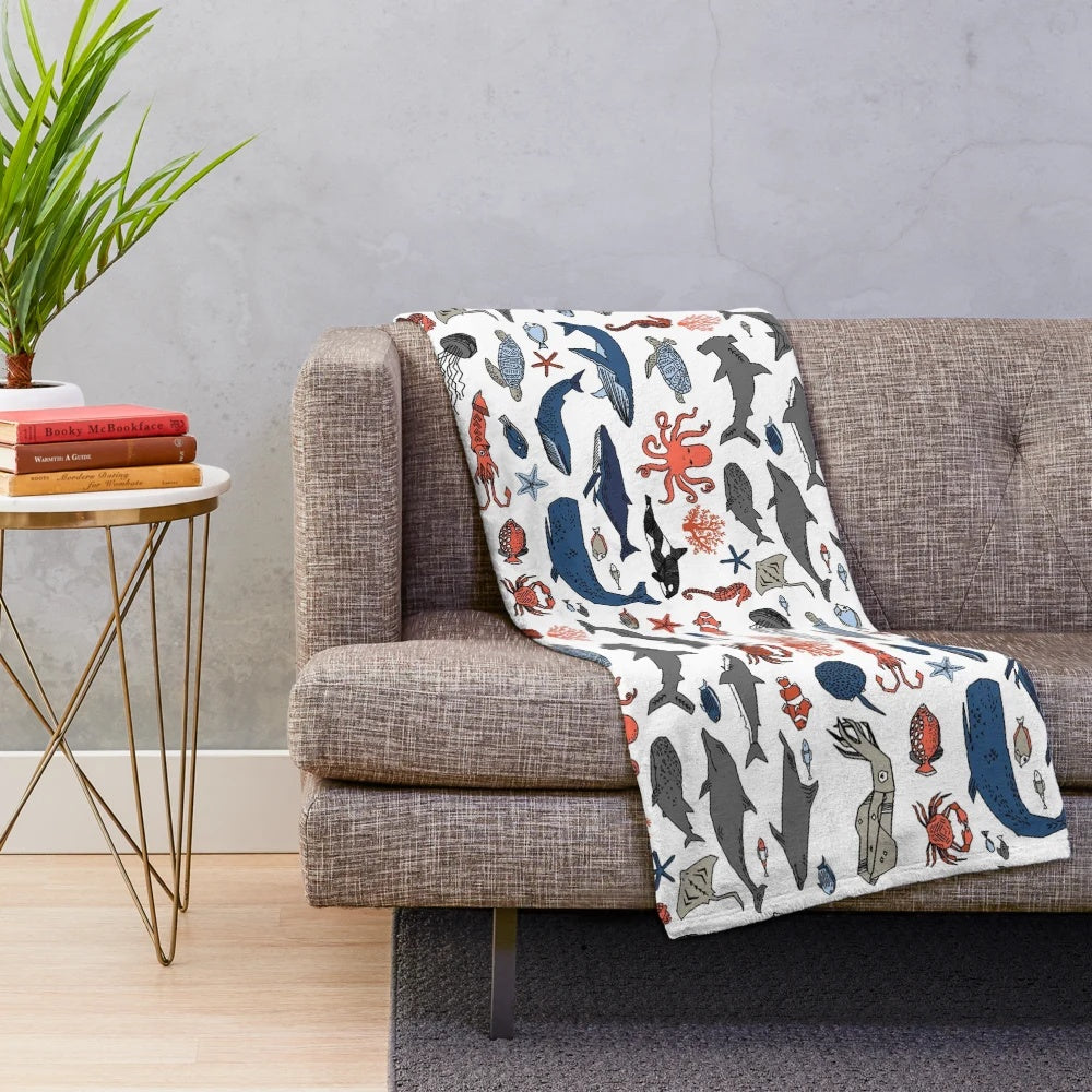 Soft and plush ocean animals blanket featuring a vibrant design by artist Andrea Lauren