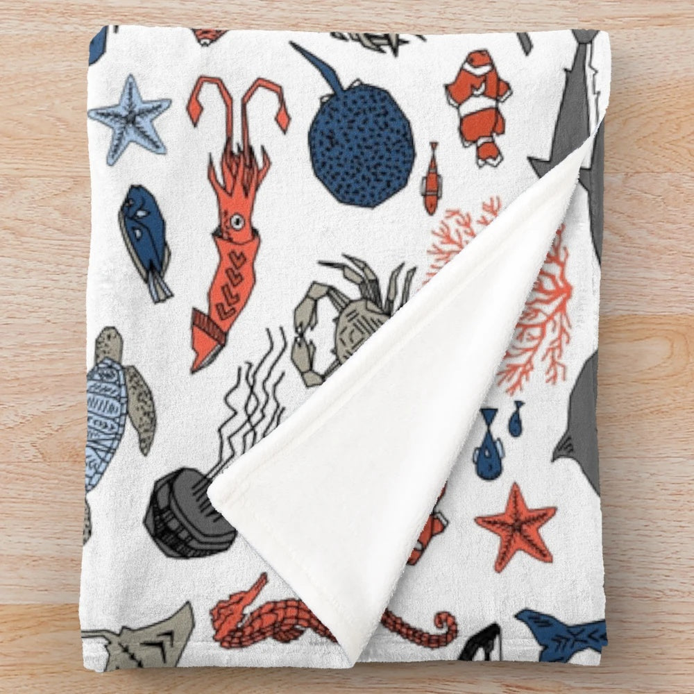 Soft and plush ocean animals blanket featuring a vibrant design by artist Andrea Lauren