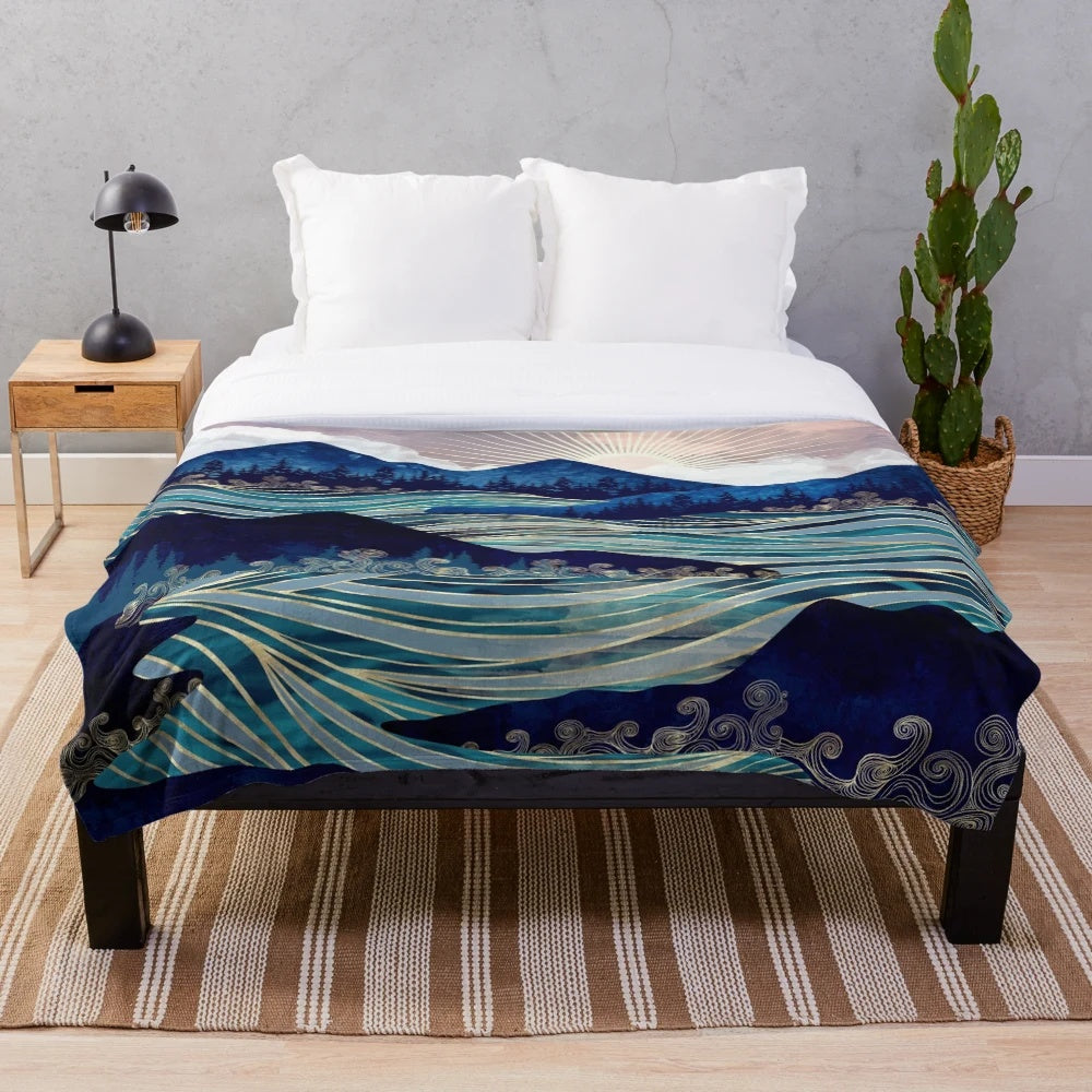Ocean sunrise-inspired plush blanket with vibrant colors and abstract landscape design