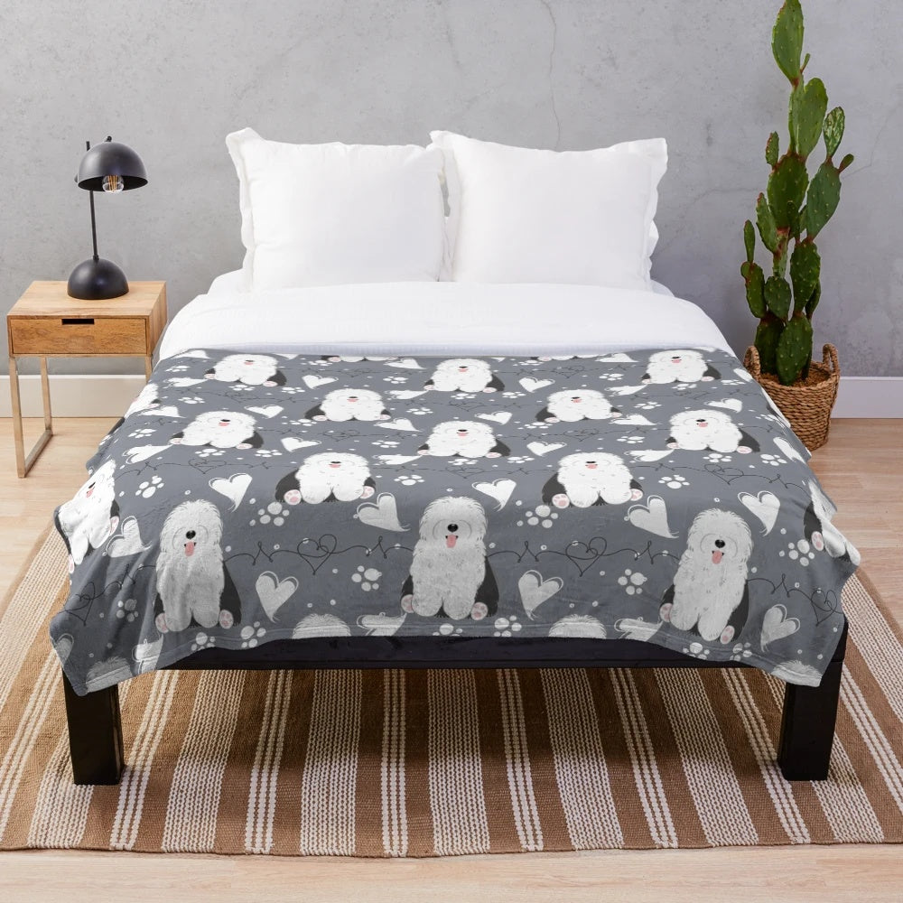 Soft and cuddly plush blanket featuring a black and white old English sheepdog design