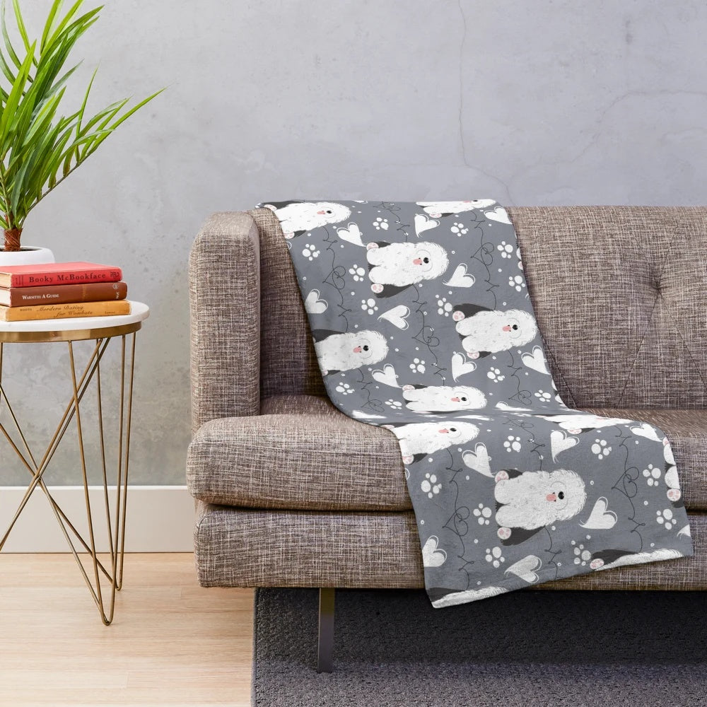 Soft and cuddly plush blanket featuring a black and white old English sheepdog design