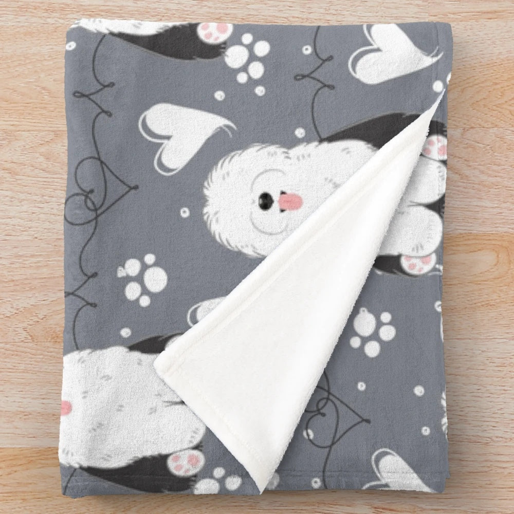 Soft and cuddly plush blanket featuring a black and white old English sheepdog design