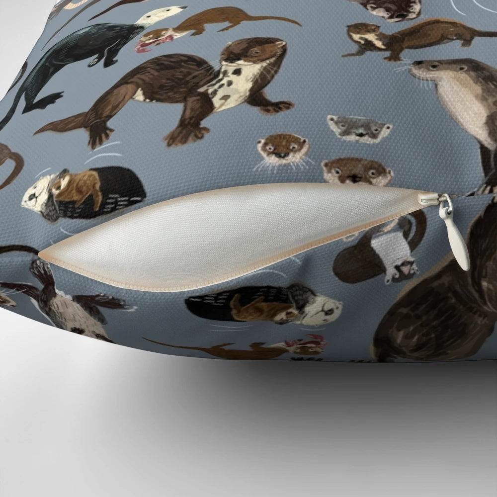A soft, grey otter pattern pillow featuring adorable otters in a whimsical, vintage-inspired design.