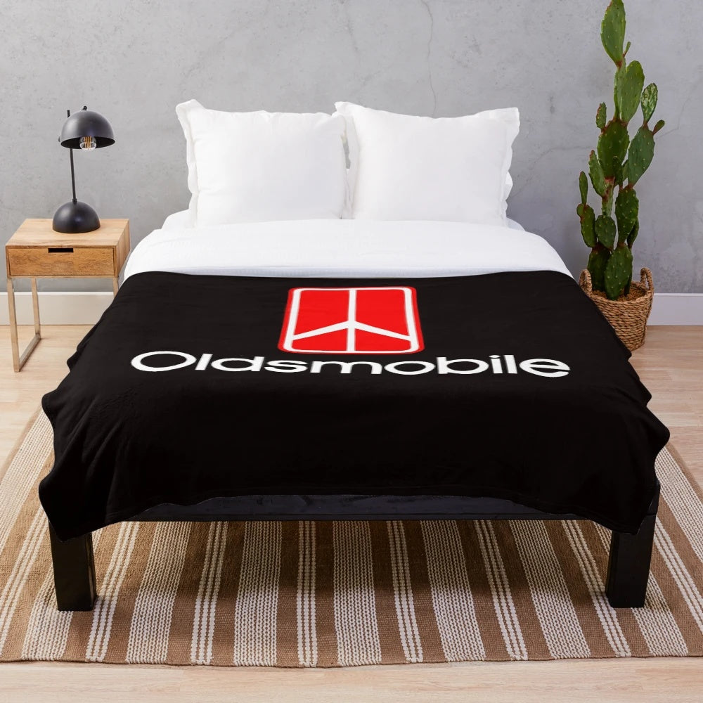 Oldsmobile logo printed on a soft, plush blanket