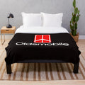 Oldsmobile logo printed on a soft, plush blanket