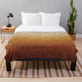 Ombre burnt orange, yellow, and tan plush blanket with a crosshatch pattern