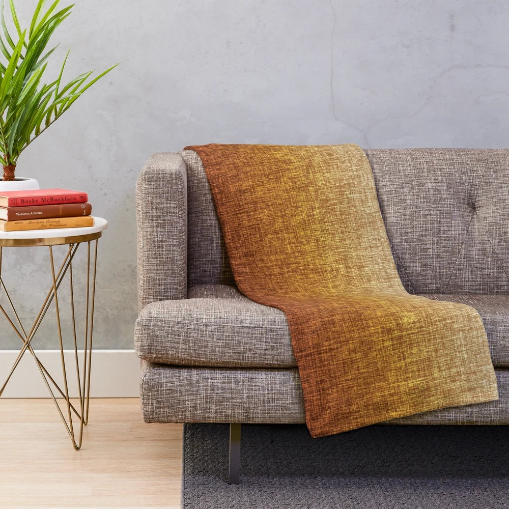Ombre burnt orange, yellow, and tan plush blanket with a crosshatch pattern