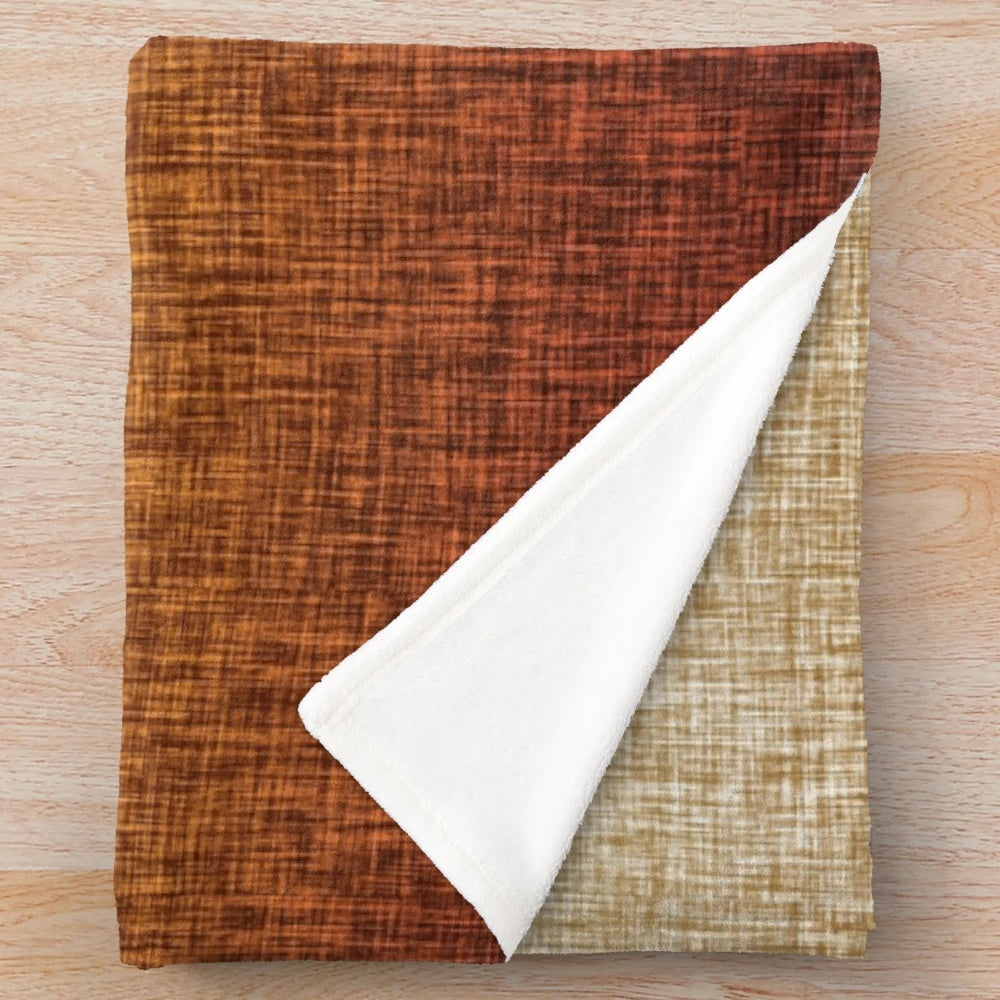 Ombre burnt orange, yellow, and tan plush blanket with a crosshatch pattern