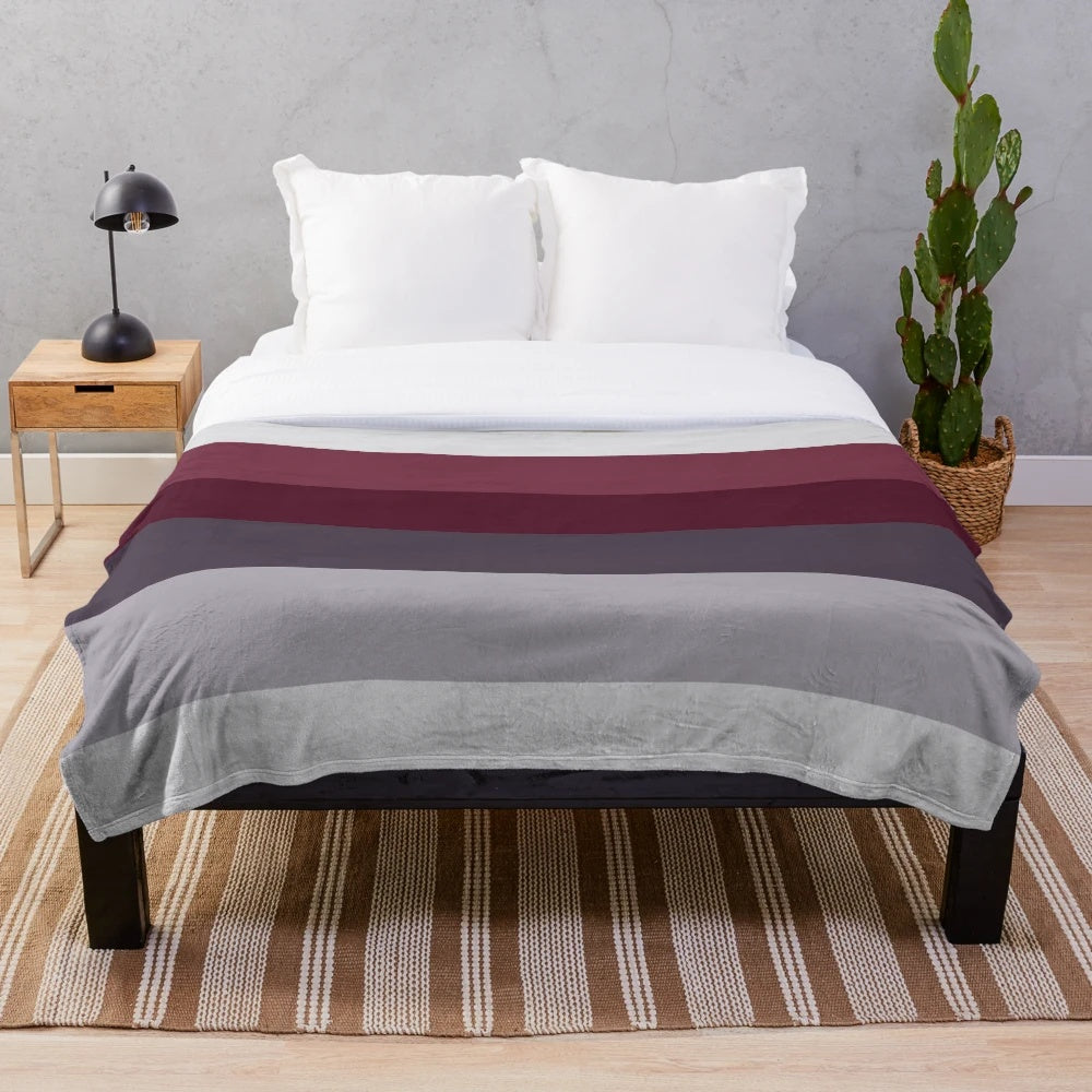 Ombre plush blanket in burgundy, plum, and gray tones