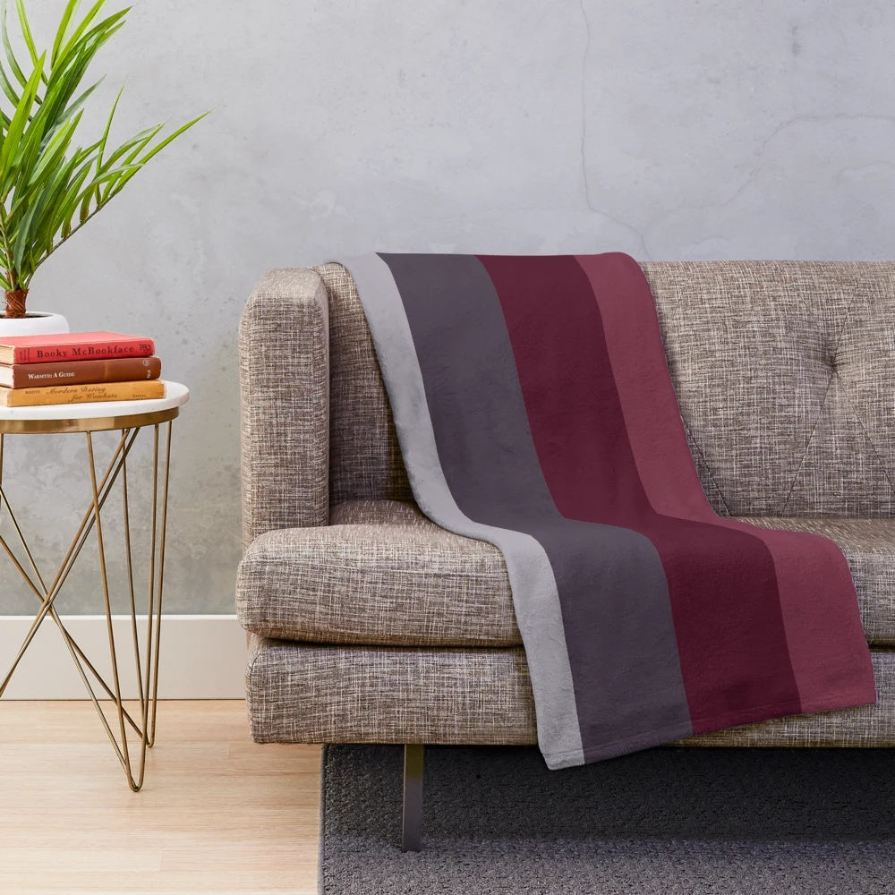 Ombre plush blanket in burgundy, plum, and gray tones