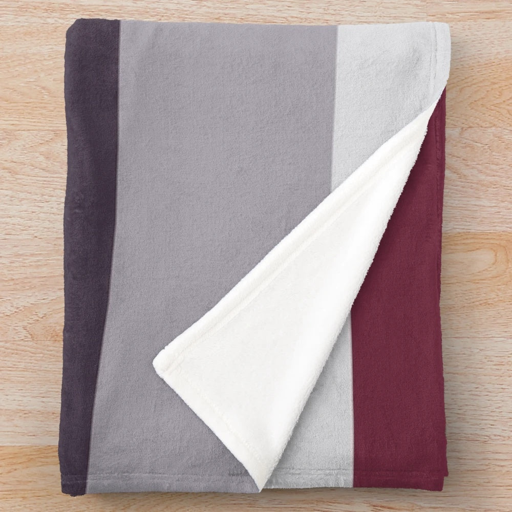 Ombre plush blanket in burgundy, plum, and gray tones