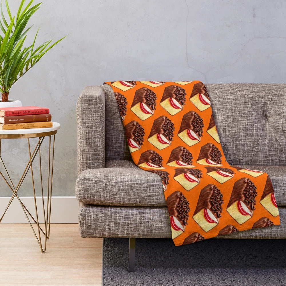 Orange plush blanket with a vintage, retro design inspired by the classic Mexican Gansito snack cake