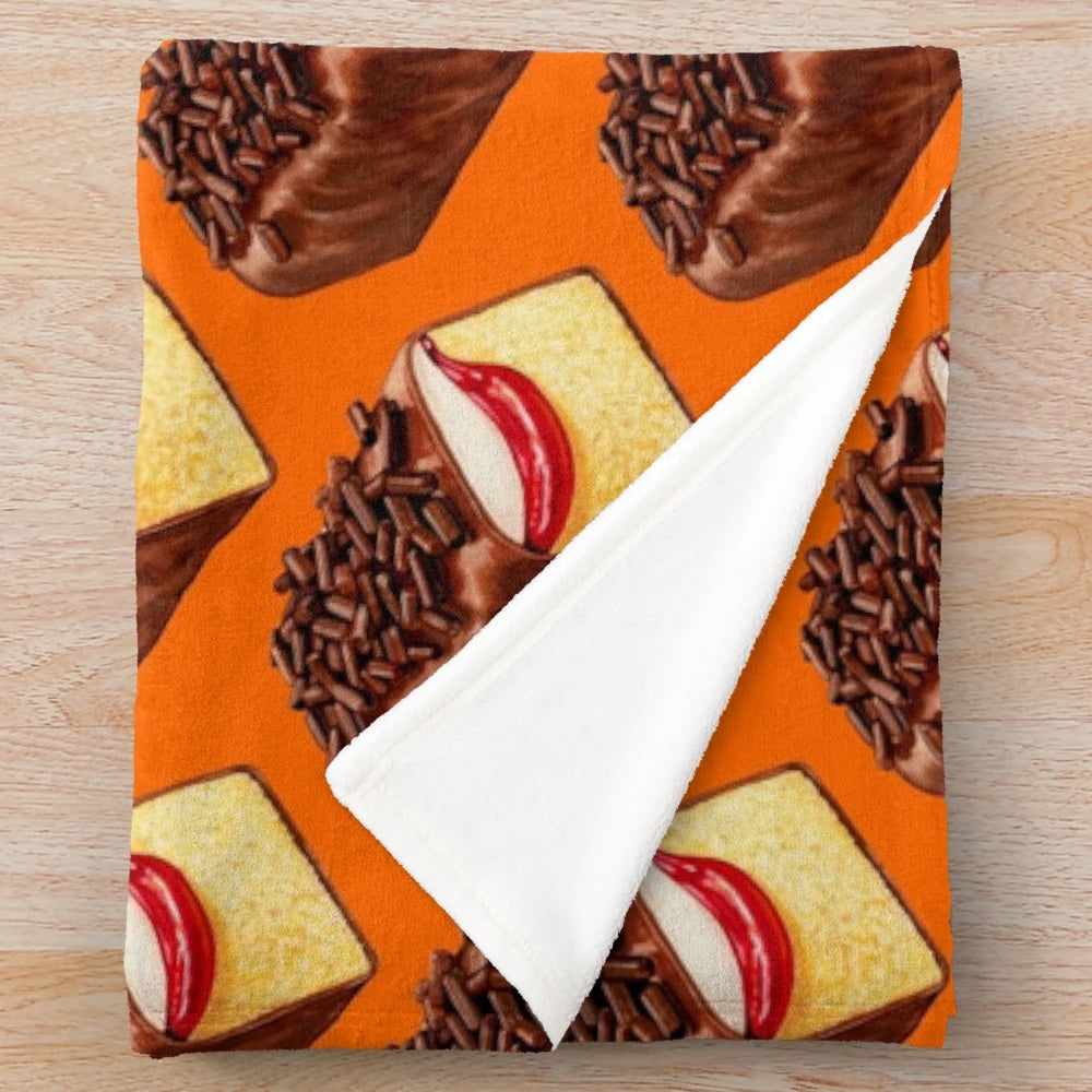Orange plush blanket with a vintage, retro design inspired by the classic Mexican Gansito snack cake