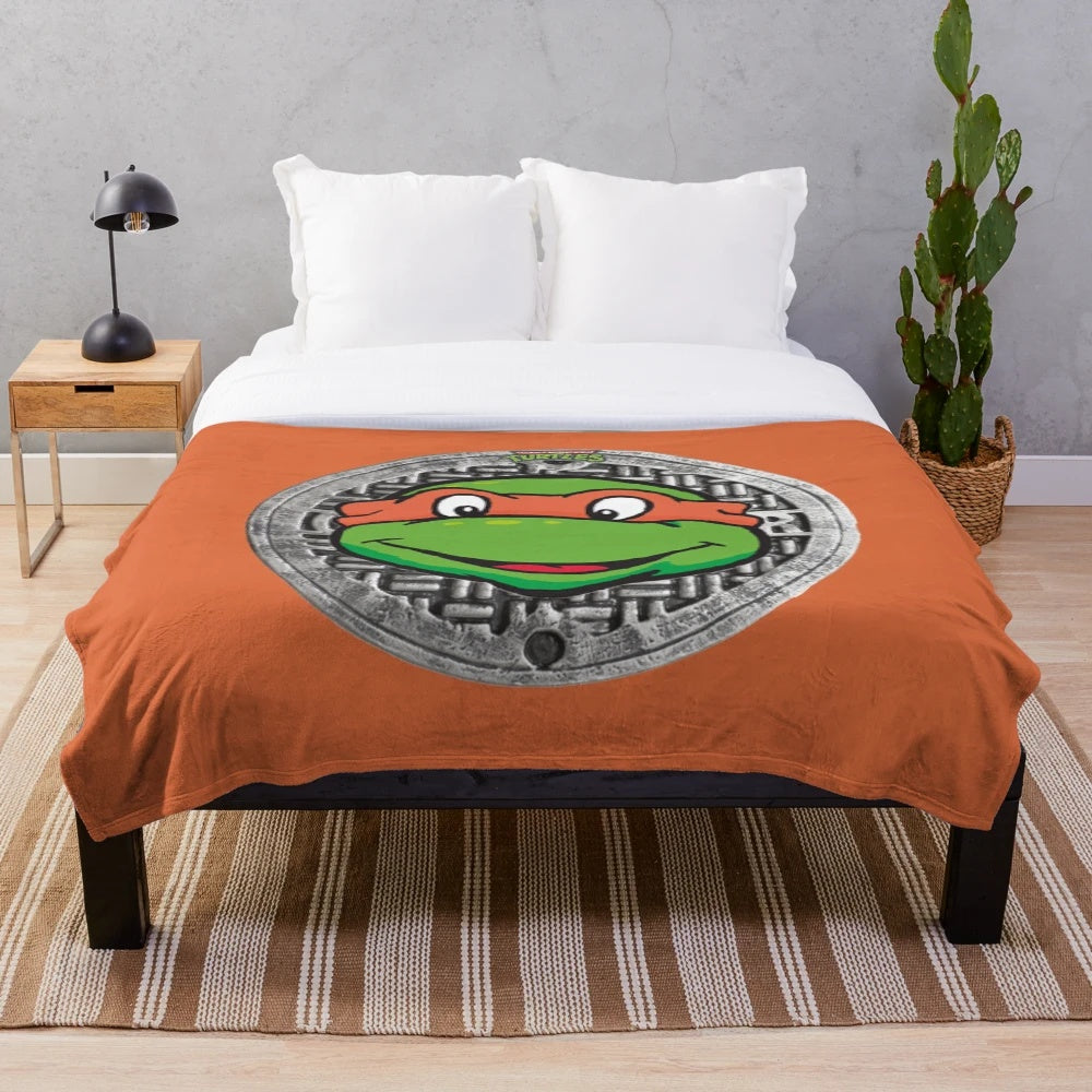Orange plush blanket featuring the beloved cartoon character Michelangelo from Teenage Mutant Ninja Turtles